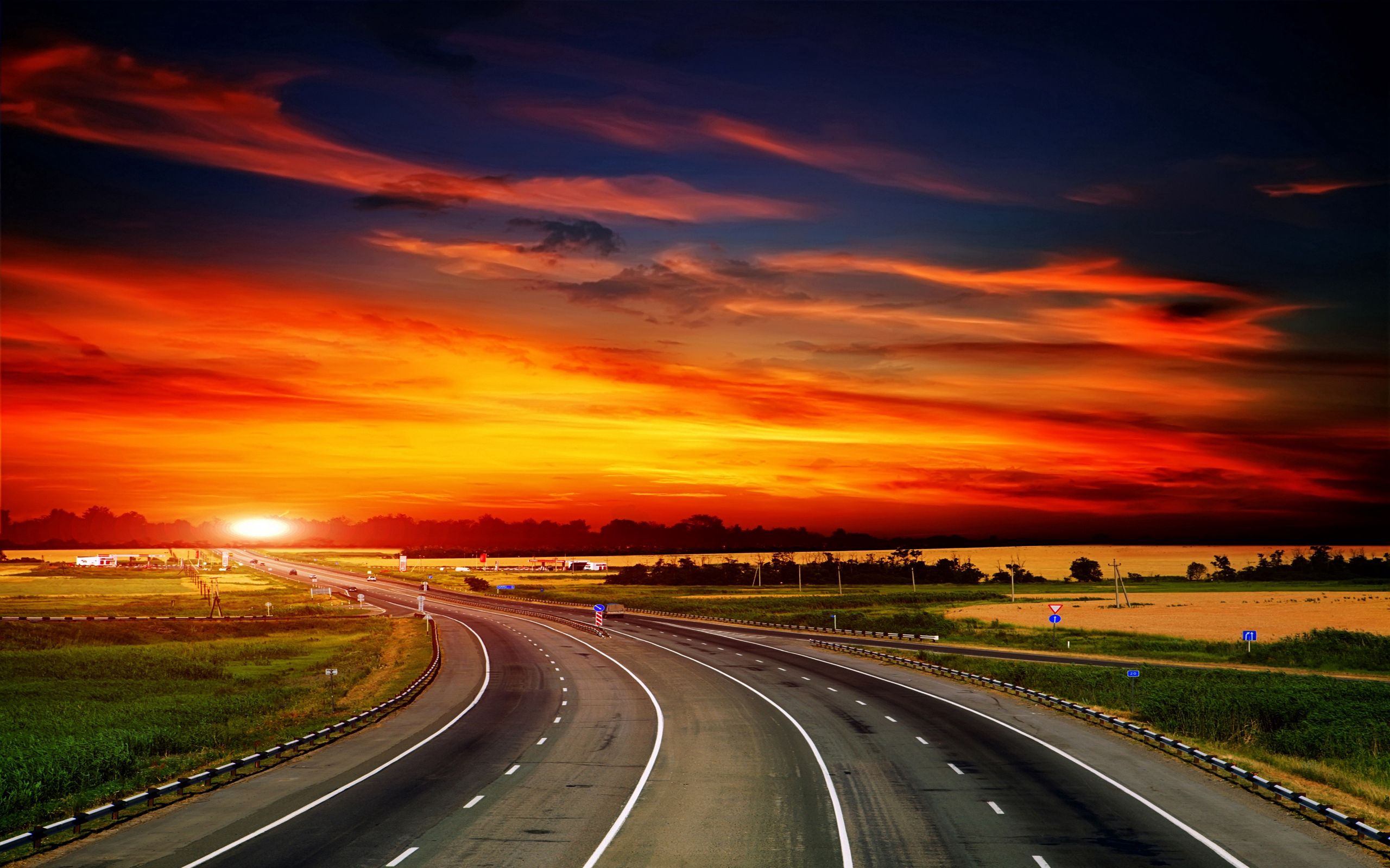 103164 download wallpaper nature, sunset, sky, signs, orange, road, turn, asphalt, evening screensavers and pictures for free