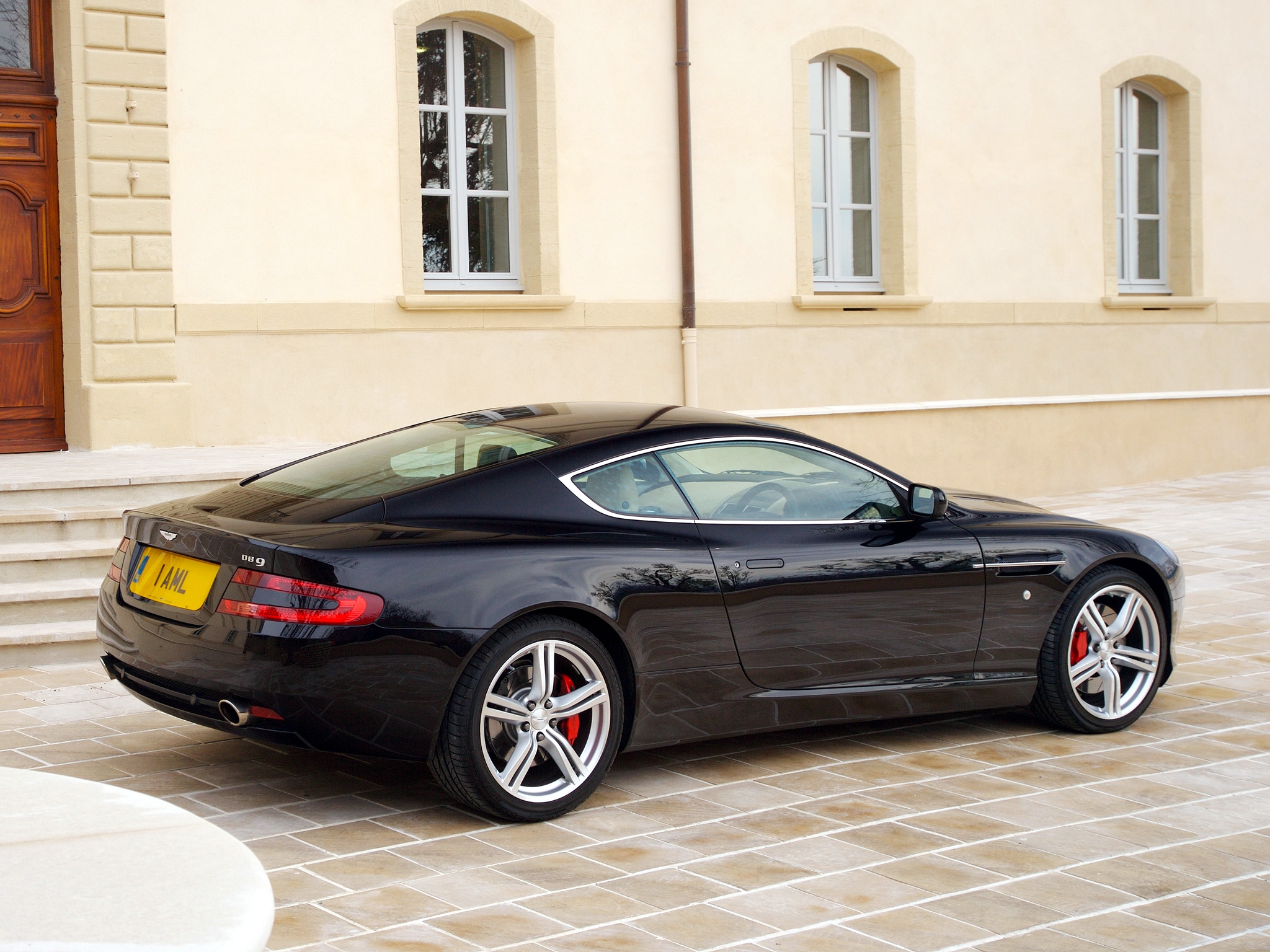 58830 download wallpaper sports, auto, aston martin, cars, black, building, side view, style, db9, 2006 screensavers and pictures for free