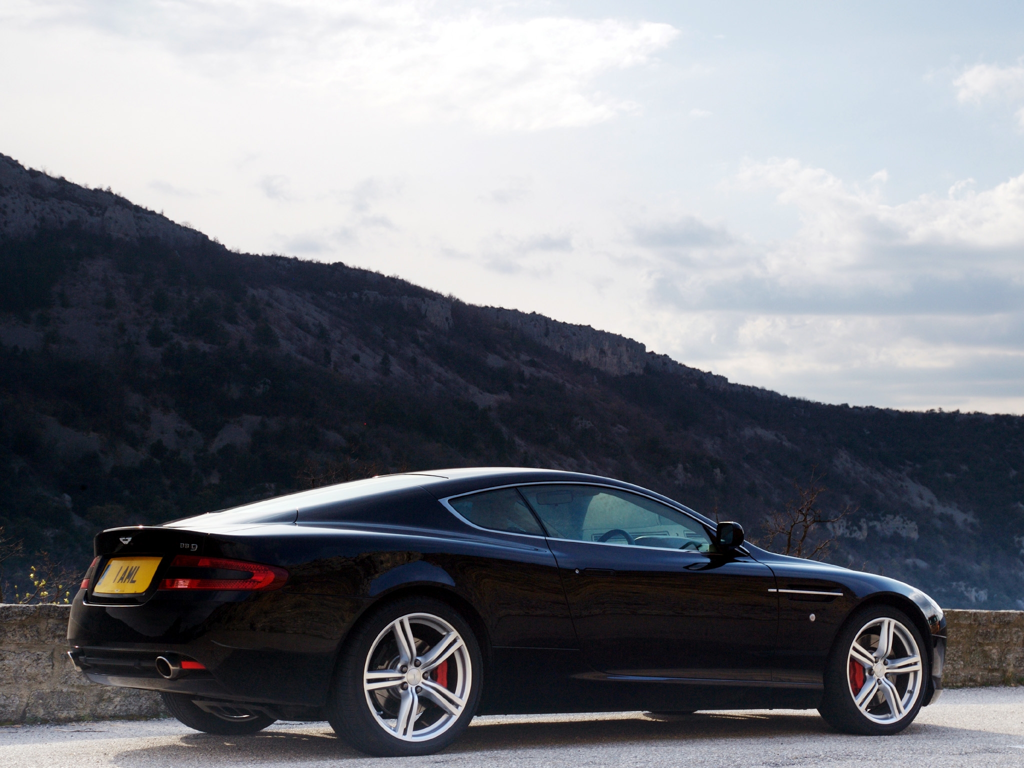 85367 download wallpaper sports, auto, nature, trees, sky, mountains, aston martin, cars, black, side view, style, db9, 2006 screensavers and pictures for free