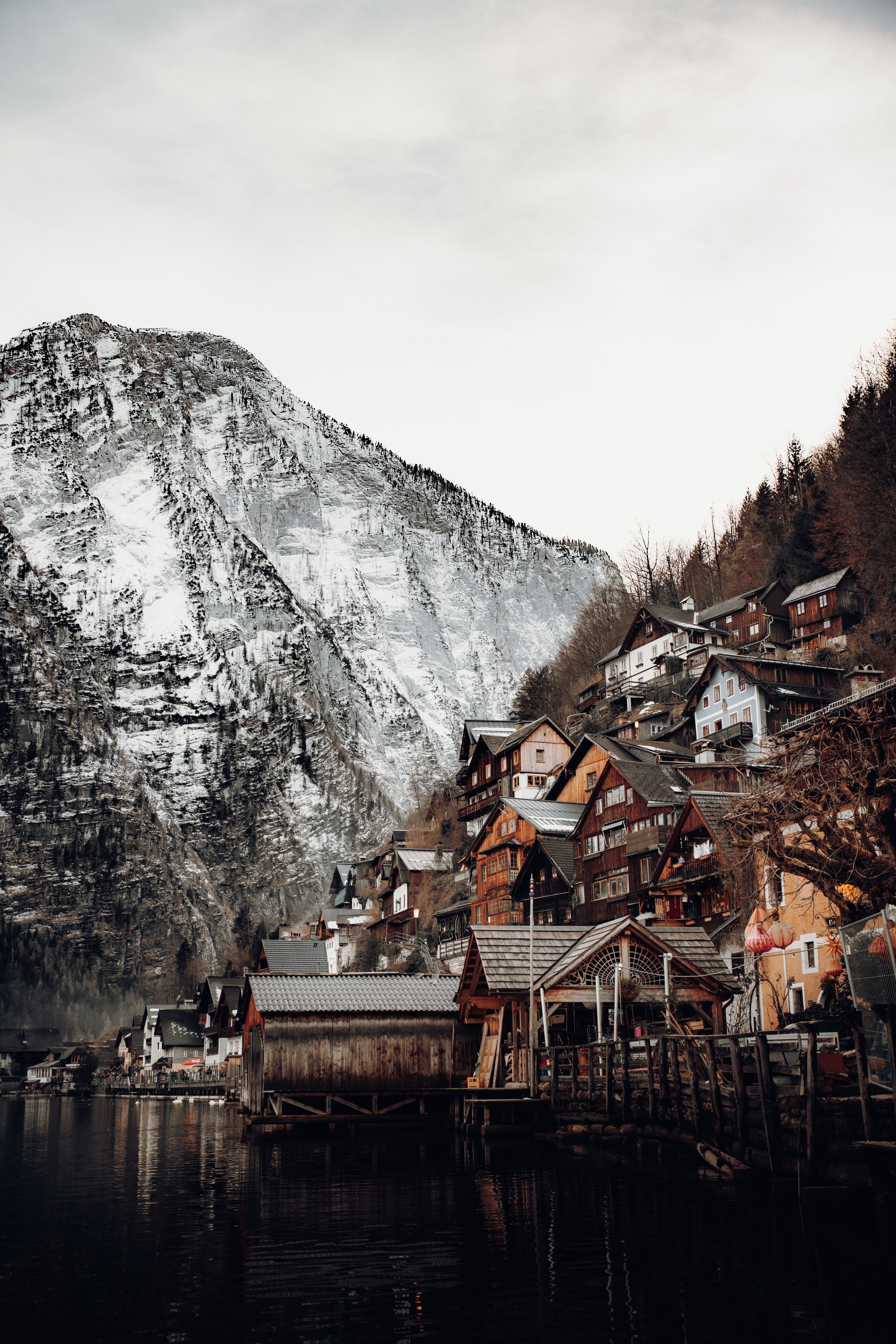 116000 download wallpaper snow, nature, houses, mountains, on the river bank screensavers and pictures for free