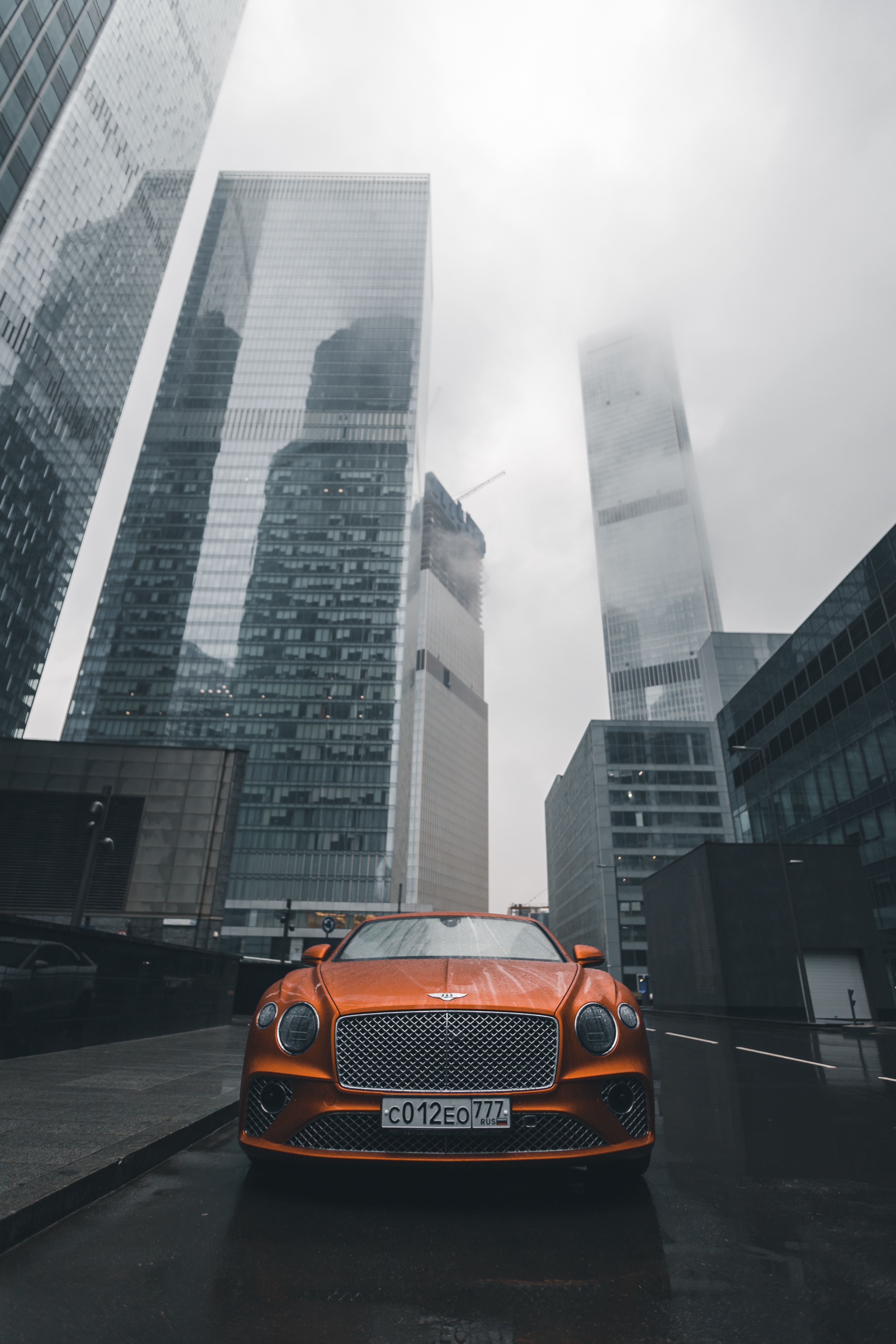 52580 Screensavers and Wallpapers Bentley for phone. Download bentley, cars, orange, city, building, car, front view, machine, bentley continental gt pictures for free