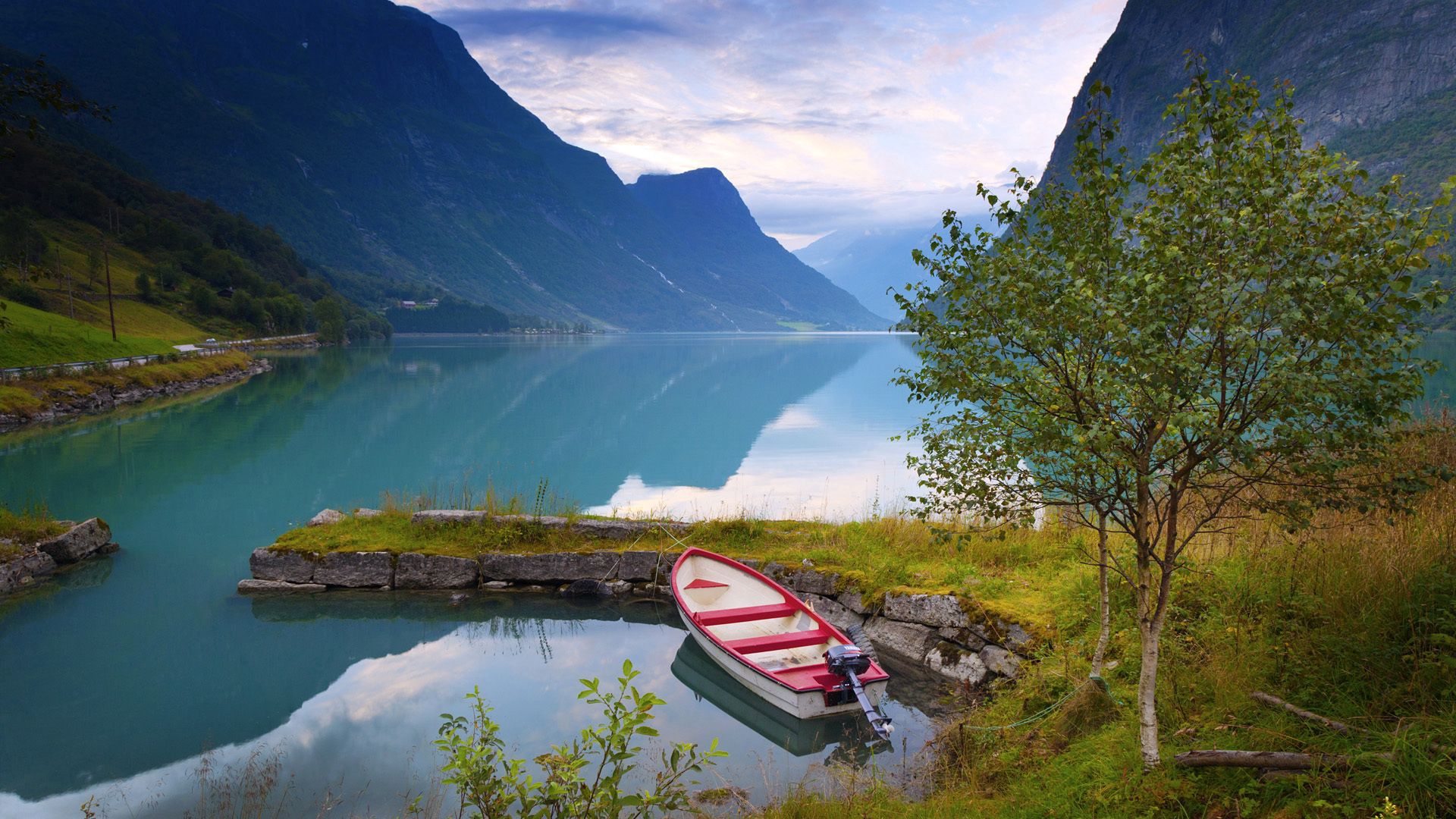 lake, blue water, norway, boat, nature, grass, stones, mountains, shore, bank QHD