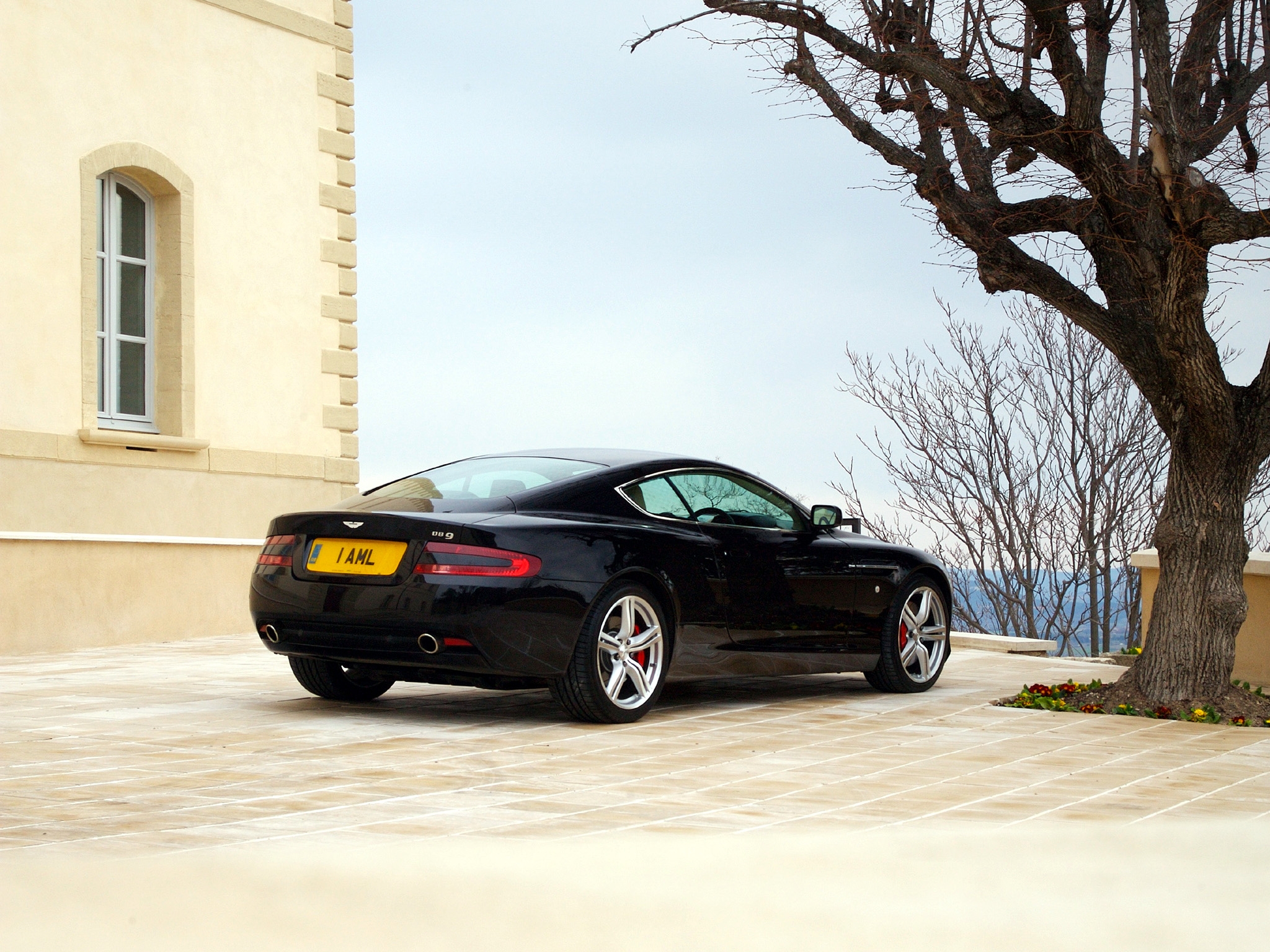 88605 download wallpaper sports, auto, sky, aston martin, cars, black, building, wood, tree, side view, style, db9, 2006 screensavers and pictures for free