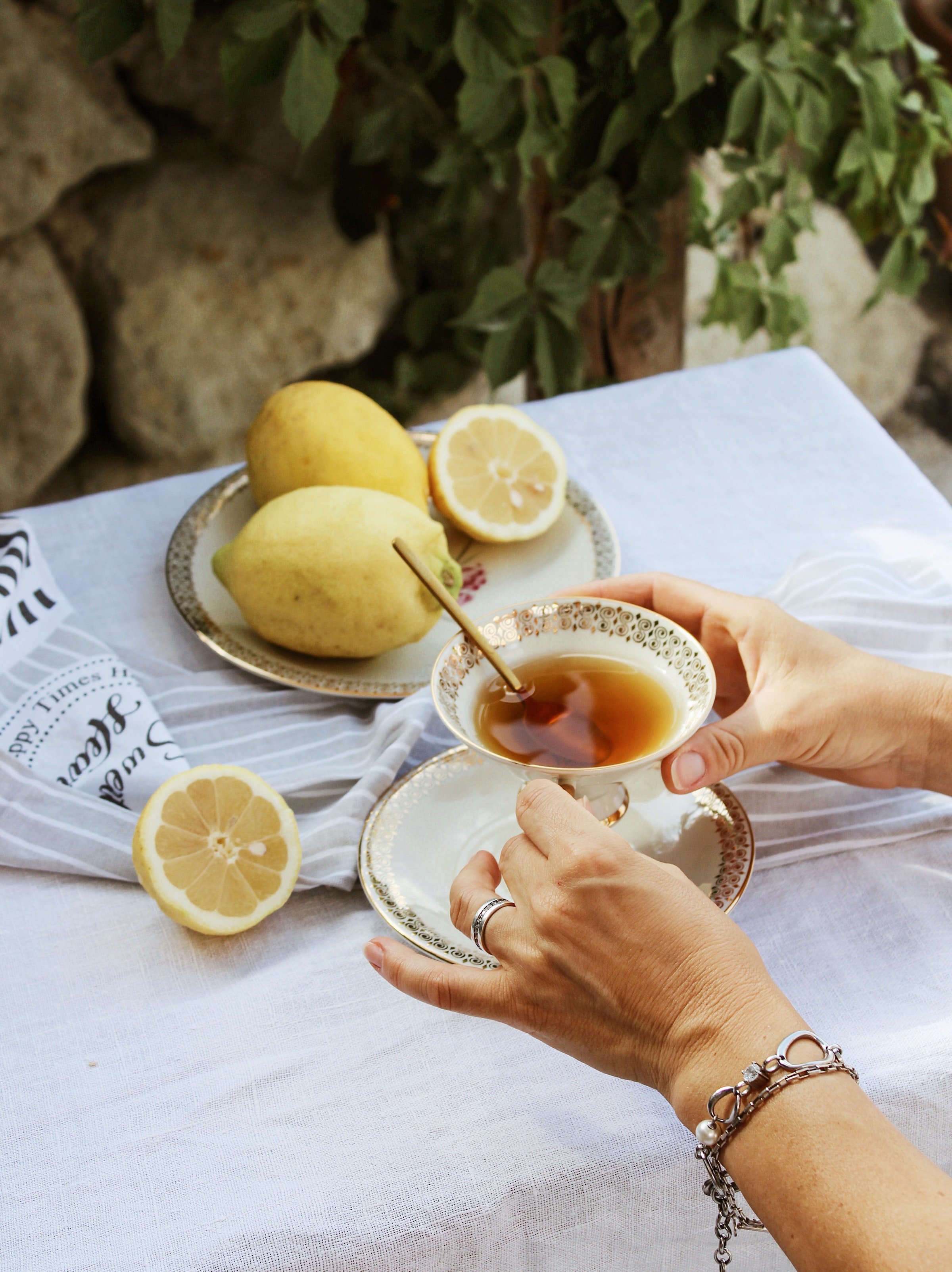 food, rings, cup, hands, lemon, tablecloth