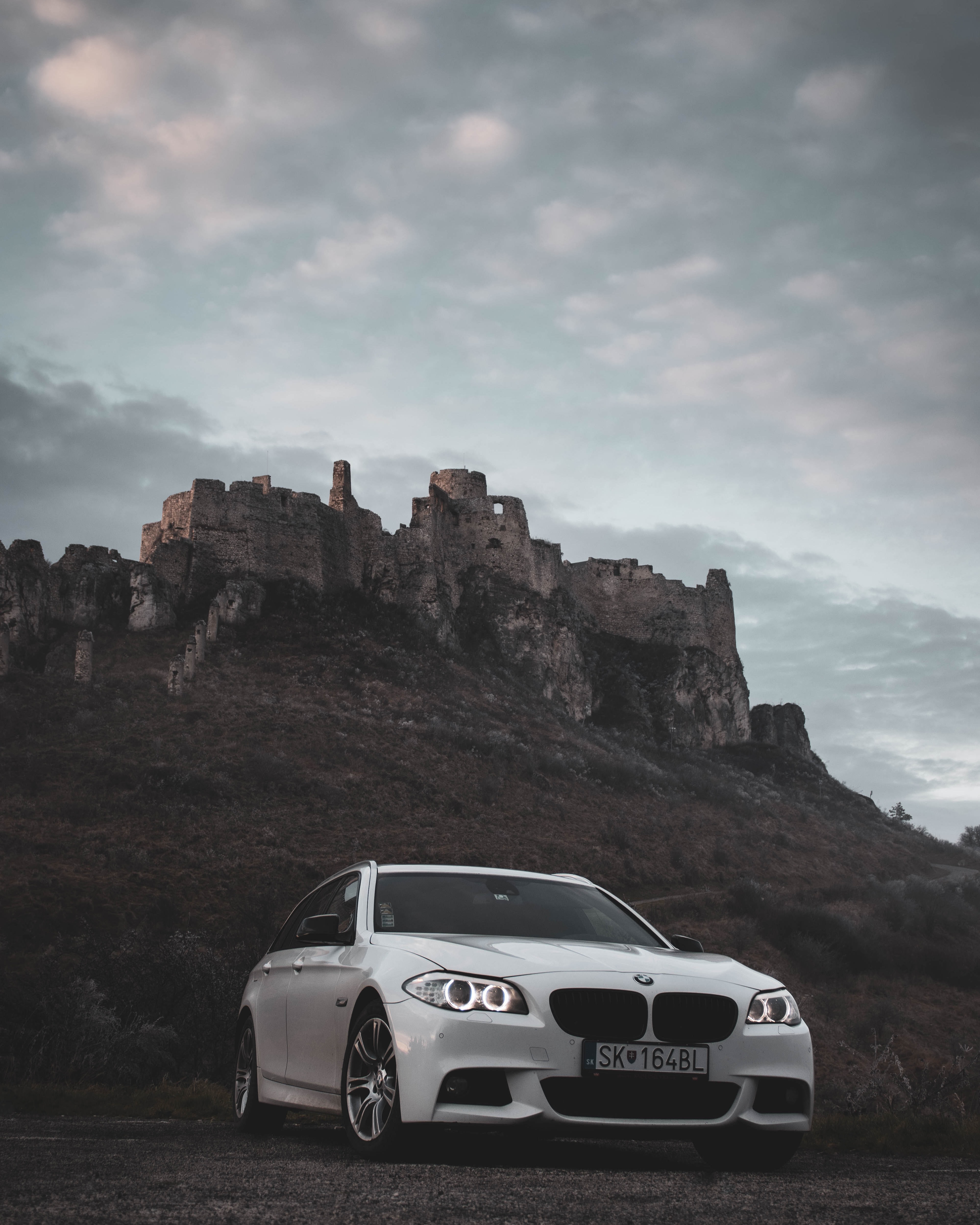 104936 download wallpaper front view, nature, bmw, cars, white, rock, car screensavers and pictures for free