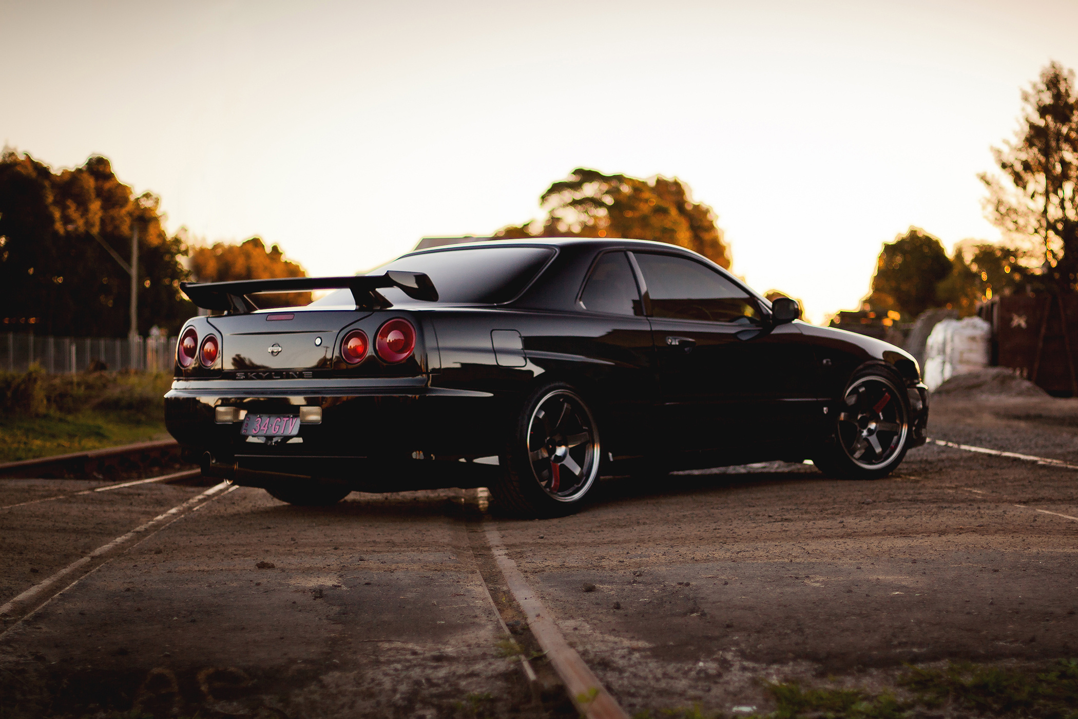 152234 download wallpaper skyline, gtr, nissan, cars, black, side view, r34, railroad screensavers and pictures for free