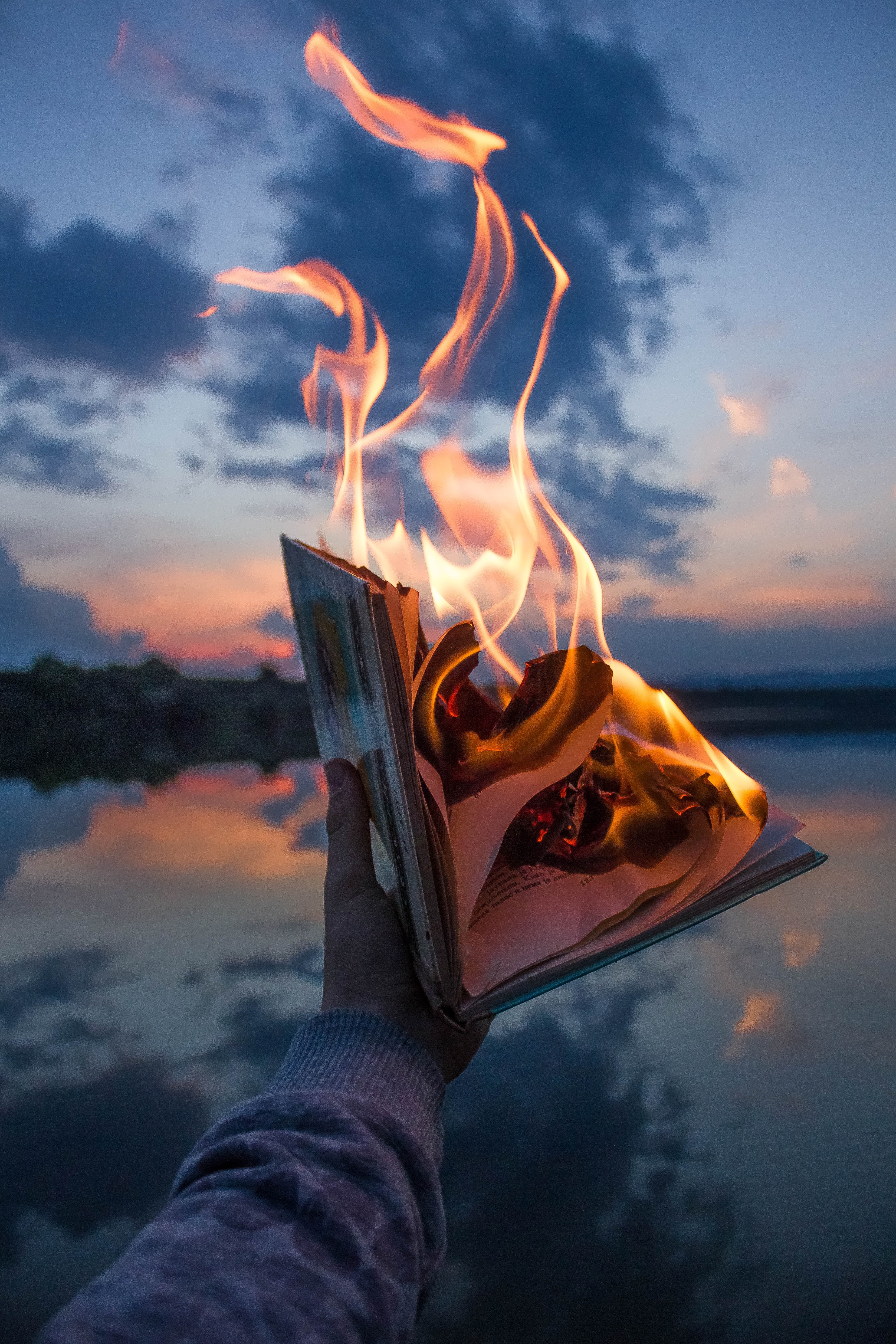 Download mobile wallpaper Hand, Miscellanea, Flame, Twilight, Dusk, Fire, Book, Miscellaneous for free.