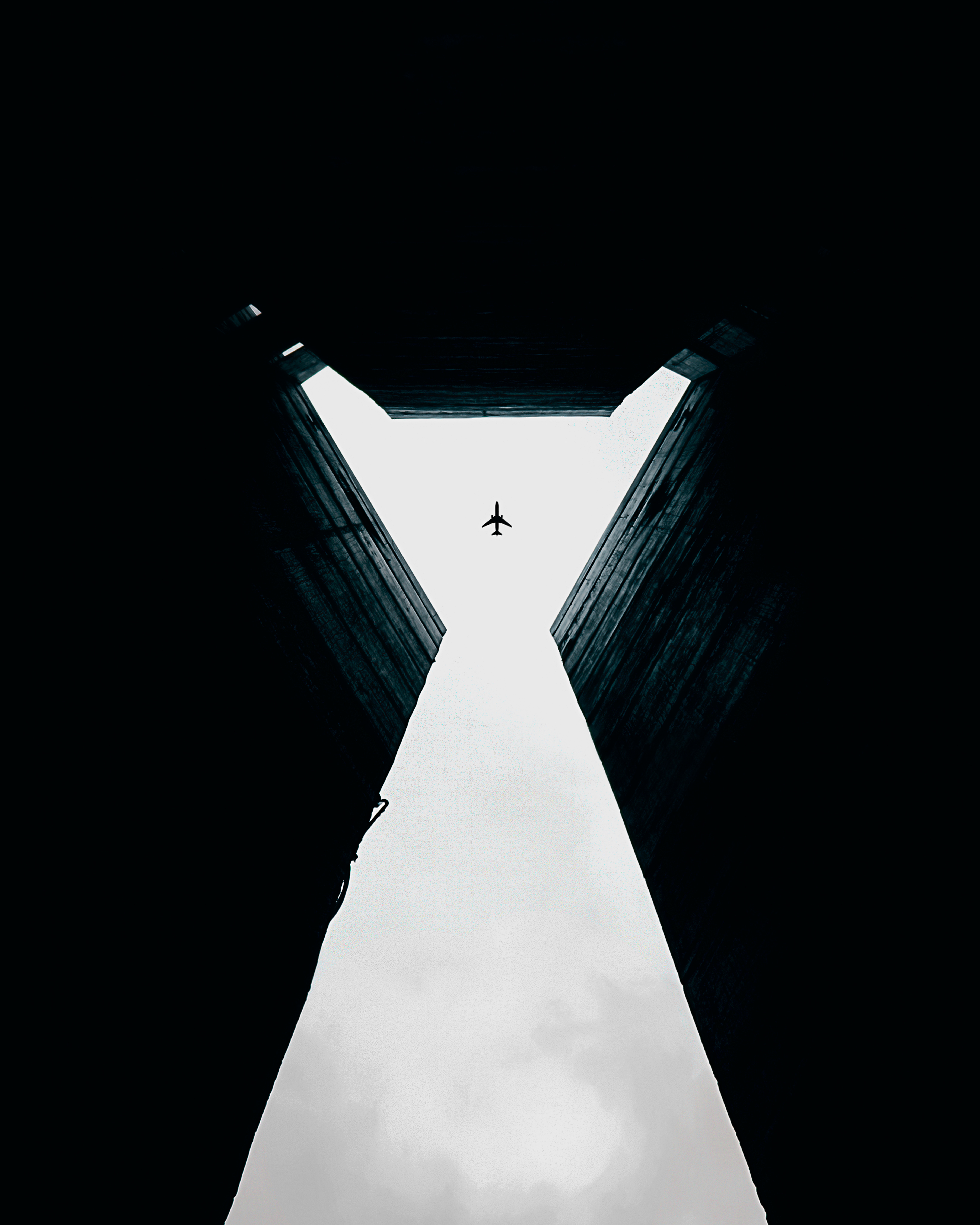 155225 download wallpaper minimalism, sky, walls, building, dark, symmetry, plane, airplane, bottom view, high, opening, aperture screensavers and pictures for free