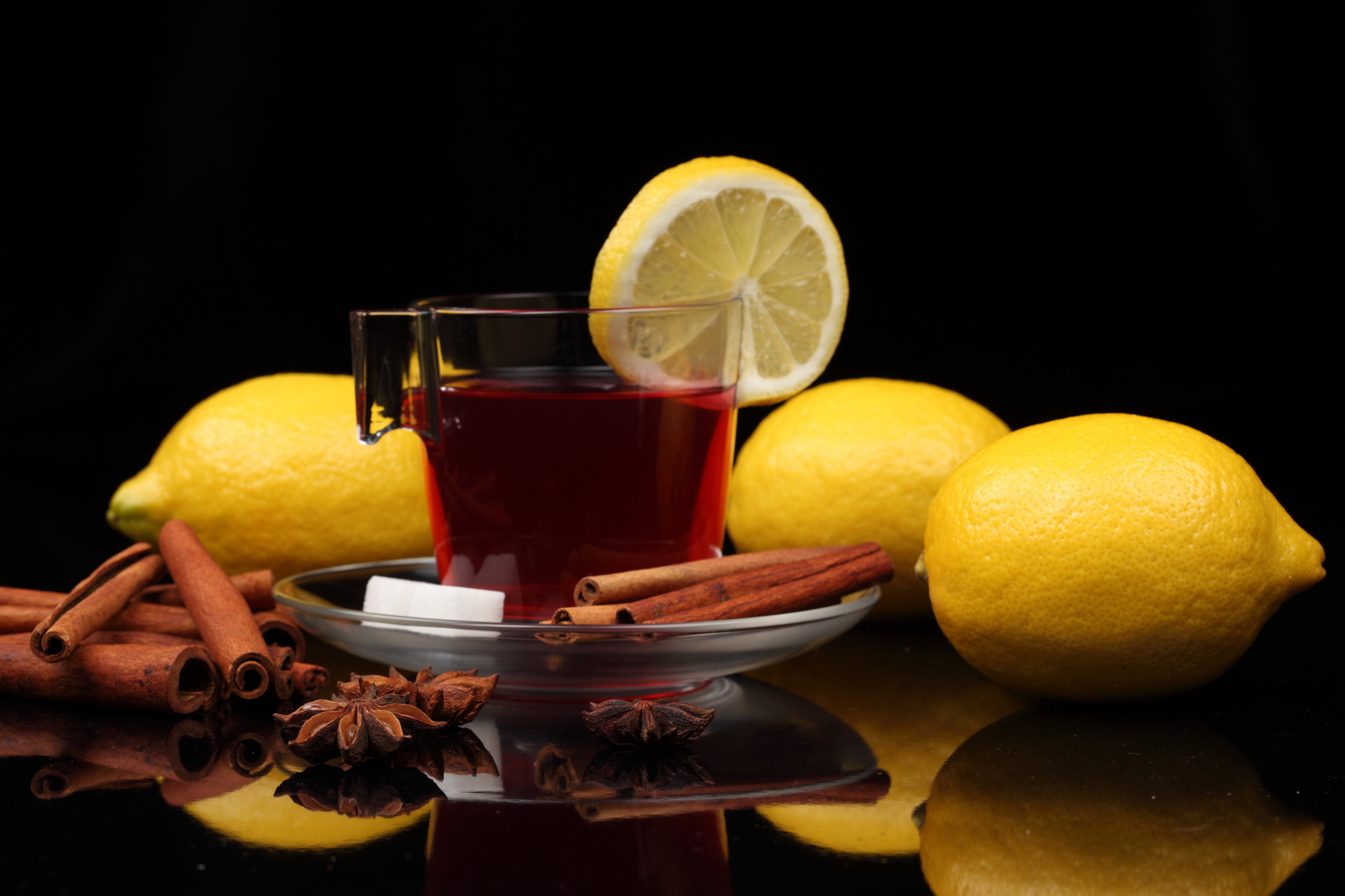 104588 download wallpaper cup, food, cinnamon, lemon, black background, tea, sugar screensavers and pictures for free