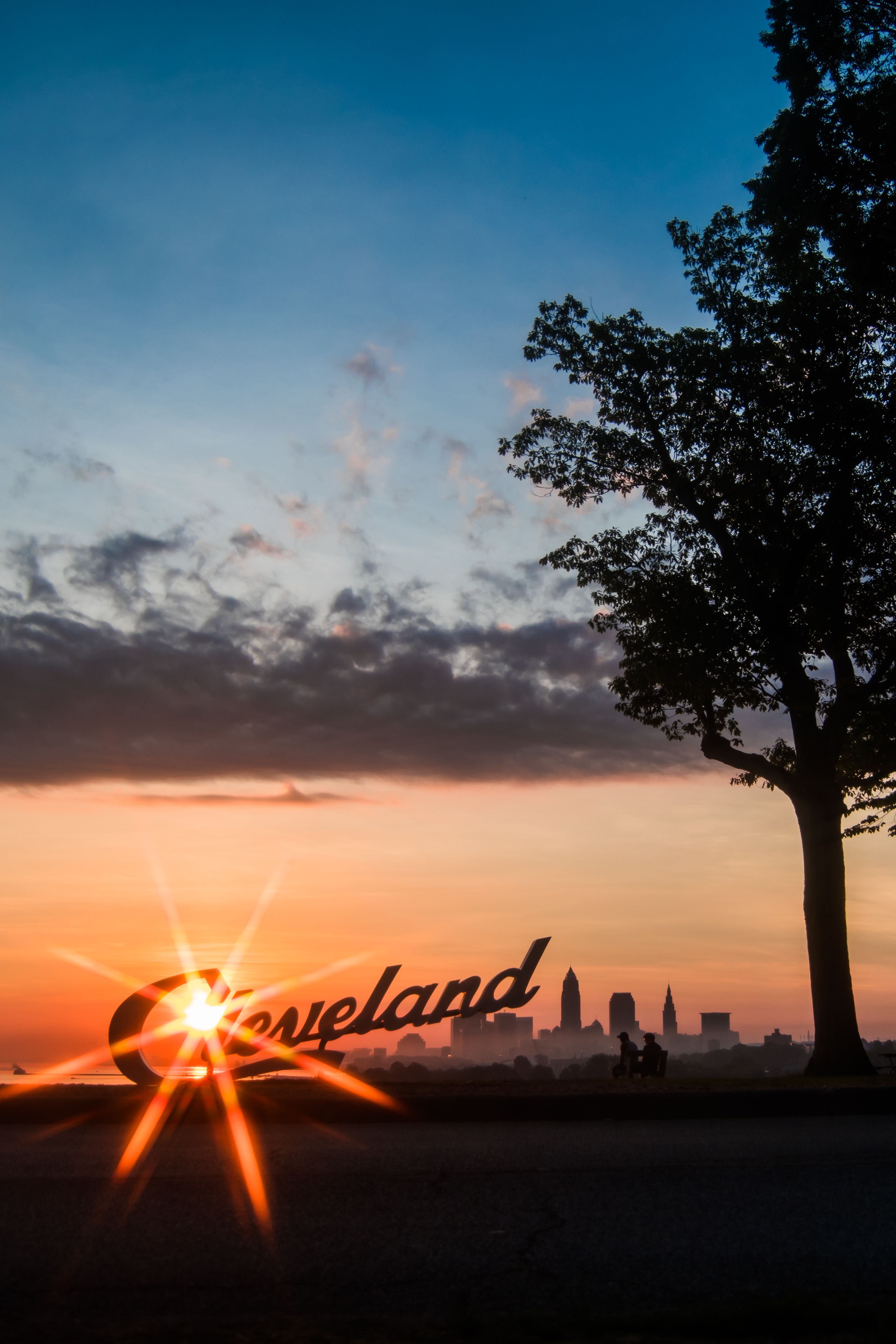 cities, sunset, silhouettes, night city, inscription, sunlight, cleveland Full HD