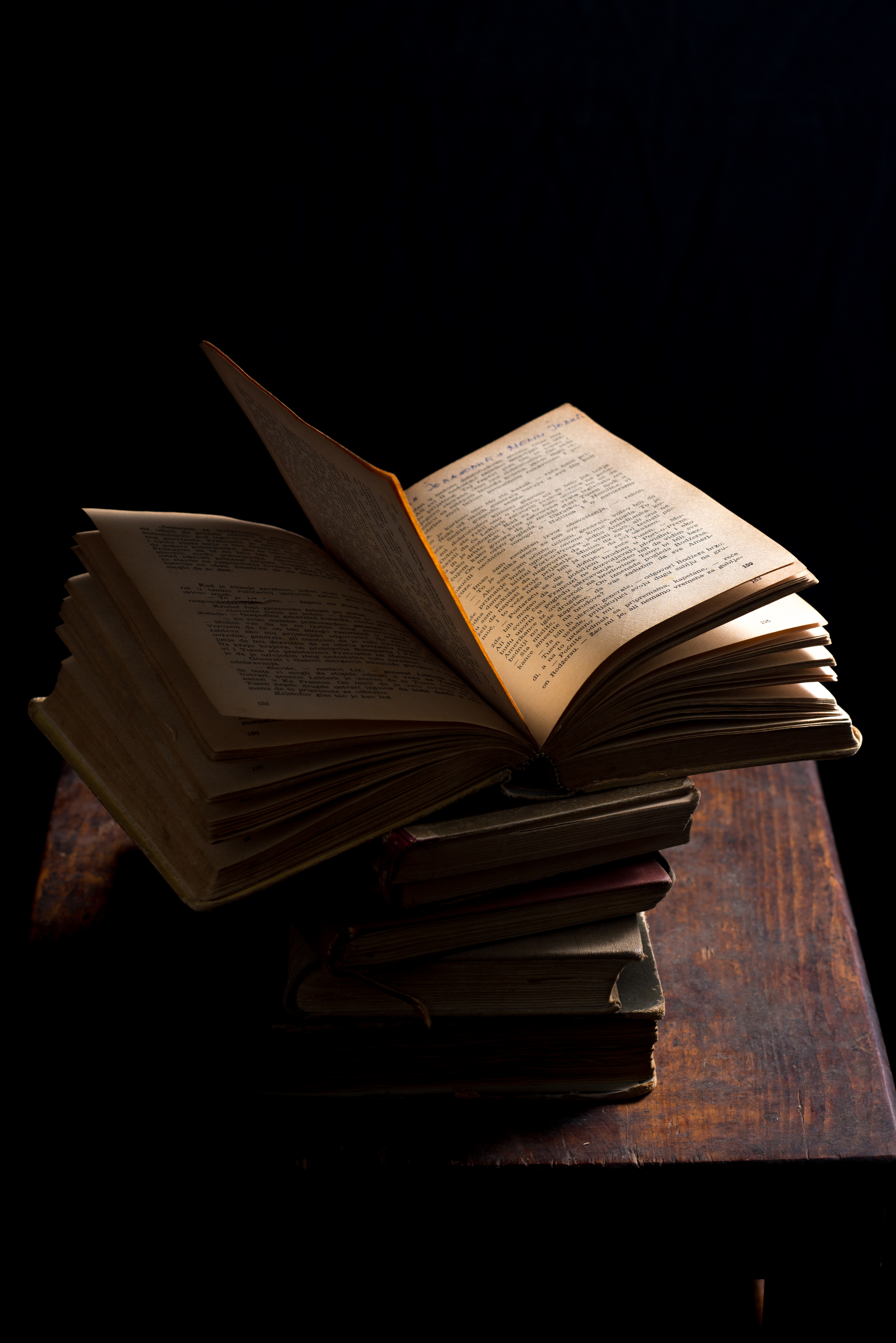 books, darkness, miscellanea, miscellaneous, table, pages, page mobile wallpaper