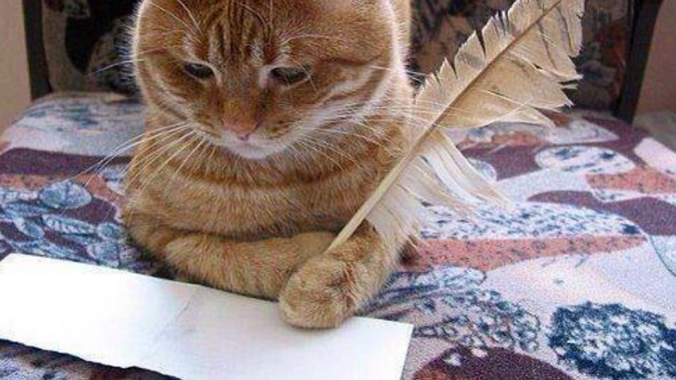 кот пишет пером сидит за столом