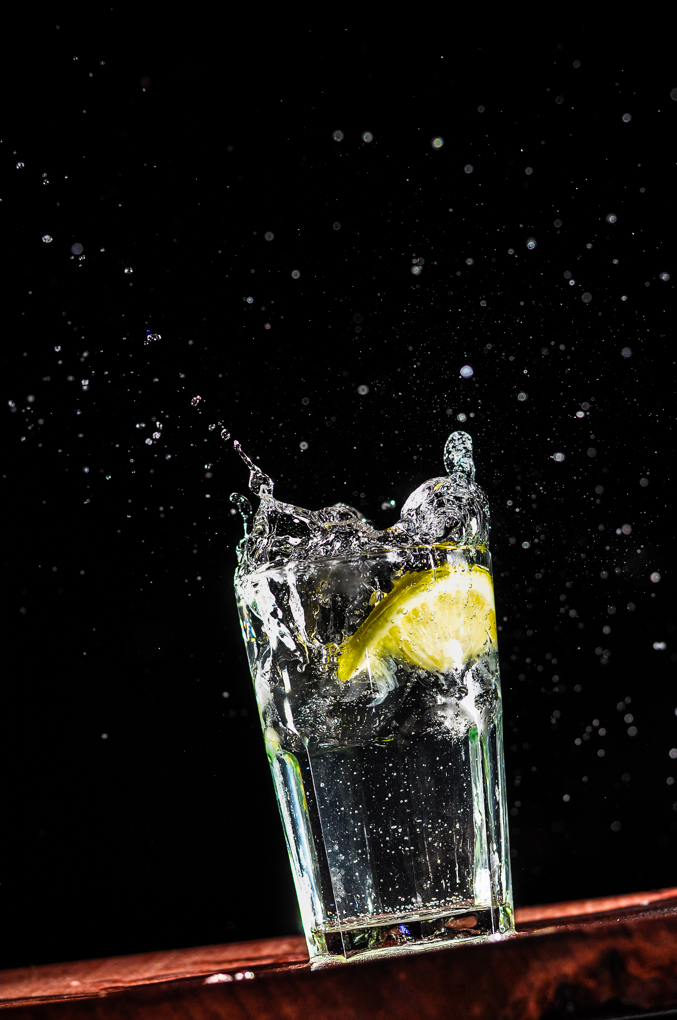141445 download wallpaper glass, macro, liquid, water, drops, spray, lemon screensavers and pictures for free