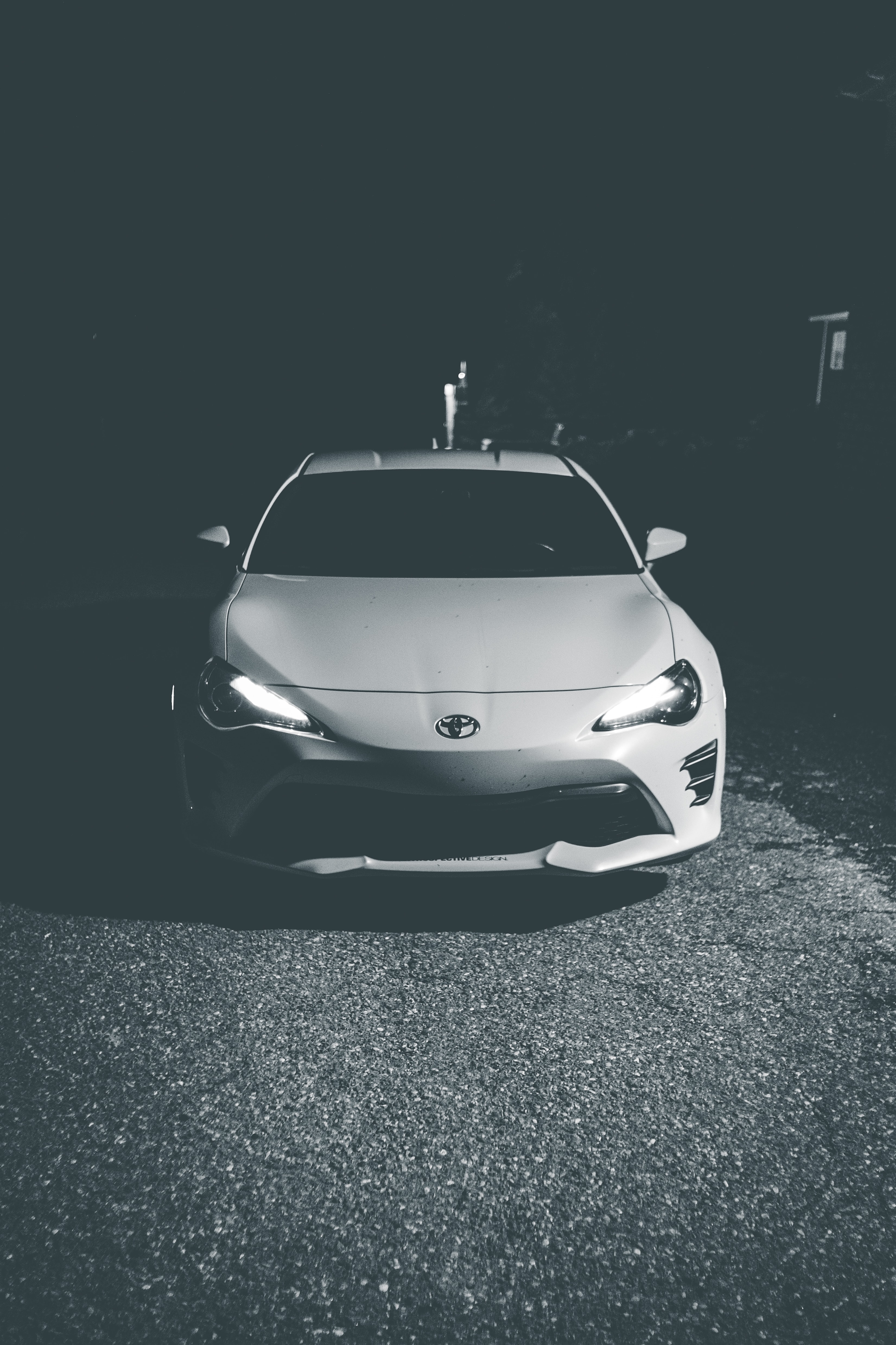 102149 download wallpaper toyota, cars, lights, car, front view, machine, bw, chb, headlights screensavers and pictures for free